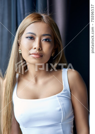 Fashion close-up portrait of young Asian woman posing near to window Fashion close-up portrait of young Asian woman posing near to window 78896537