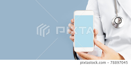 Doctor holding a mockup smartphone with an medical app Doctor holding a mockup smartphone with an medical app 78897045