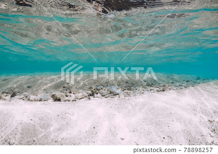 Underwater ocean with sand and little stones in Hawaii. Water background 78898257