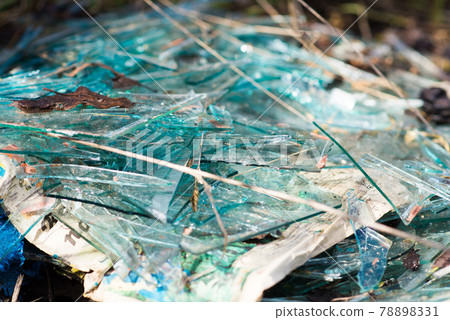 Broken blue glass in the forest dump Broken blue glass in the forest dump 78898331