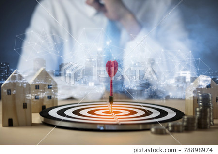 Targeting the business concept, Businessman touch red arrow dart to the virtual target dartboard, Executive marketing, investment goal and target for business investment concept, mini home. 78898974