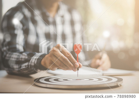 Targeting the business concept, Businessman throwing red arrow dart to virtual target dart board,Executive marketing, investment goal and target for business investment concept. 78898980