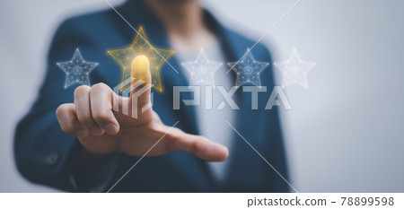 The concept of placing rating. Businessman touching technology on five star excellent rating on blue background, Concept of satisfaction, quality and performance of services.Copy space for web banner. The concept of placing rating. Businessman touching technology on five star excellent rating on blue background, Concept of satisfaction, quality and performance of services.Copy space for web banner. 78899598