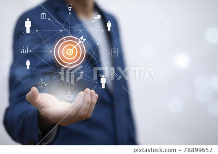 Targeting the business concept, Businessman holding arrow dart to virtual target dart board,Executive marketing, investment goal and target for business investment concept. 78899652