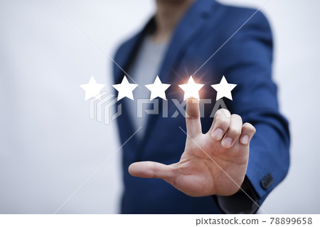 The concept of placing rating. Businessman touching technology on five star excellent rating on blue background, Concept of satisfaction, quality and performance of services.Copy space for web banner. The concept of placing rating. Businessman touching technology on five star excellent rating on blue background, Concept of satisfaction, quality and performance of services.Copy space for web banner. 78899658