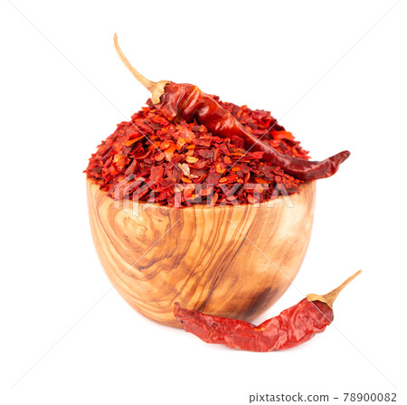 Dried red chili flakes in olive bowl, isolated on white background. Chopped chilli cayenne pepper. Spices and herbs. Dried red chili flakes in olive bowl, isolated on white background. Chopped chilli cayenne pepper. Spices and herbs. 78900082