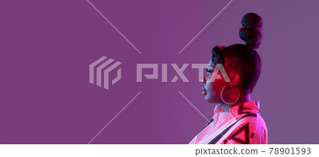 Young beautiful happy African girl isolated on purple background in neon. Flyer Young beautiful happy African girl isolated on purple background in neon. Flyer 78901593