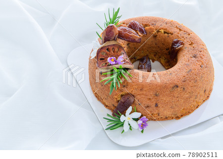 Date Cake and Decorate with dried dates. dried quince and rosemary leaves Date Cake and Decorate with dried dates. dried quince and rosemary leaves 78902511