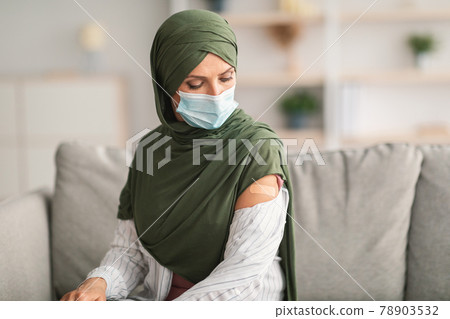 Arabic Woman Looking At Vaccinated Arm With Plaster At Home 78903532