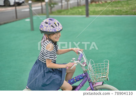 Girl running on a bicycle Girl running on a bicycle 78904110