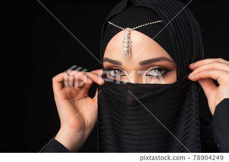 Close up portrait of beautiful muslim girl dressed in hijab Close up portrait of beautiful muslim girl dressed in hijab 78904249