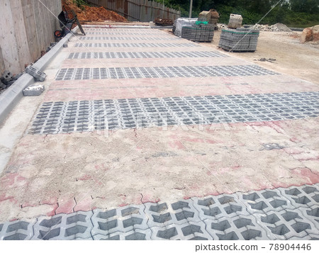 PENANG, MALAYSIA -JUNE 16, 2021: Concrete interlocking pavers and material under construction at the construction site. Used for pedestrian walkway and parking lot.  Advantages in durability and heav 78904446