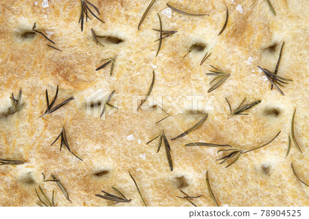 Italian focaccia - rustic local baked from flour, olive oil, yeast, sugar, salt and water, lying on an iron baking sheet like a background - top view 78904525