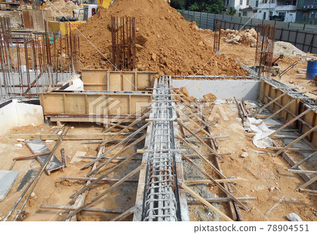 PENANG, MALAYSIA -MARCH 7, 2021: Building ground beam under construction at the site using timber plywood as the formwork. Reinforced by the reinforcement steel to strengthen the structure. PENANG, MALAYSIA -MARCH 7, 2021: Building ground beam under construction at the site using timber plywood as the formwork. Reinforced by the reinforcement steel to strengthen the structure. 78904551