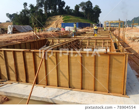 PENANG, MALAYSIA -MARCH 7, 2021: Building ground beam under construction at the site using timber plywood as the formwork. Reinforced by the reinforcement steel to strengthen the structure. PENANG, MALAYSIA -MARCH 7, 2021: Building ground beam under construction at the site using timber plywood as the formwork. Reinforced by the reinforcement steel to strengthen the structure. 78904554