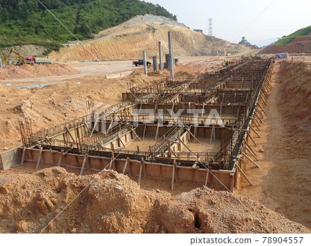 PENANG, MALAYSIA -MARCH 7, 2021: Building ground beam under construction at the site using timber plywood as the formwork. Reinforced by the reinforcement steel to strengthen the structure.  78904557