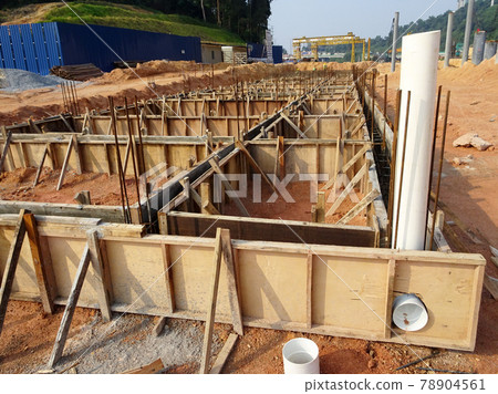 PENANG, MALAYSIA -MARCH 7, 2021: Building ground beam under construction at the site using timber plywood as the formwork. Reinforced by the reinforcement steel to strengthen the structure.  78904561