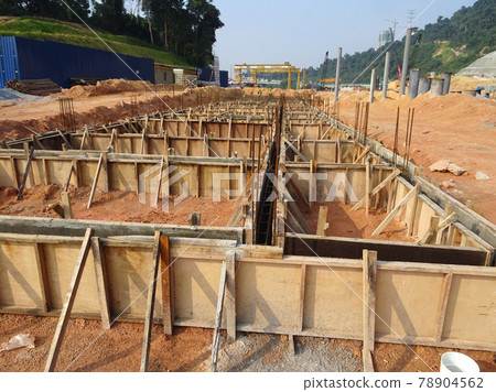 PENANG, MALAYSIA -MARCH 7, 2021: Building ground beam under construction at the site using timber plywood as the formwork. Reinforced by the reinforcement steel to strengthen the structure. PENANG, MALAYSIA -MARCH 7, 2021: Building ground beam under construction at the site using timber plywood as the formwork. Reinforced by the reinforcement steel to strengthen the structure. 78904562