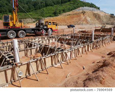 PENANG, MALAYSIA -MARCH 7, 2021: Building ground beam under construction at the site using timber plywood as the formwork. Reinforced by the reinforcement steel to strengthen the structure. PENANG, MALAYSIA -MARCH 7, 2021: Building ground beam under construction at the site using timber plywood as the formwork. Reinforced by the reinforcement steel to strengthen the structure. 78904569