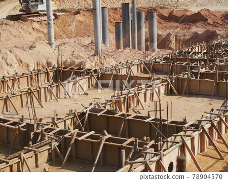 PENANG, MALAYSIA -MARCH 7, 2021: Building ground beam under construction at the site using timber plywood as the formwork. Reinforced by the reinforcement steel to strengthen the structure. PENANG, MALAYSIA -MARCH 7, 2021: Building ground beam under construction at the site using timber plywood as the formwork. Reinforced by the reinforcement steel to strengthen the structure. 78904570