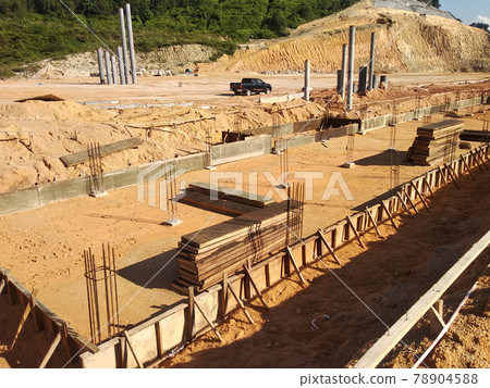 PENANG, MALAYSIA -MARCH 7, 2021: Building ground beam under construction at the site using timber plywood as the formwork. Reinforced by the reinforcement steel to strengthen the structure. PENANG, MALAYSIA -MARCH 7, 2021: Building ground beam under construction at the site using timber plywood as the formwork. Reinforced by the reinforcement steel to strengthen the structure. 78904588