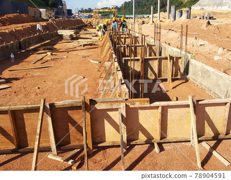 PENANG, MALAYSIA -MARCH 7, 2021: Building ground beam under construction at the site using timber plywood as the formwork. Reinforced by the reinforcement steel to strengthen the structure. PENANG, MALAYSIA -MARCH 7, 2021: Building ground beam under construction at the site using timber plywood as the formwork. Reinforced by the reinforcement steel to strengthen the structure. 78904591