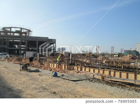 SELANGOR, SEPTEMBER 17, 2015: Building ground beam reinforcement bar and form work fabricated at site by construction workers. Concrete will be four into it after satisfied by engineer.  78905085