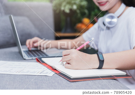 Young student watching lesson online and studying from home. She using laptop and learning online. Distance learning online education. Young student watching lesson online and studying from home. She using laptop and learning online. Distance learning online education. 78905420