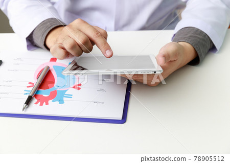 Doctor working with tablet computer at desk. Technology and medical concept. Doctor working with tablet computer at desk. Technology and medical concept. 78905512