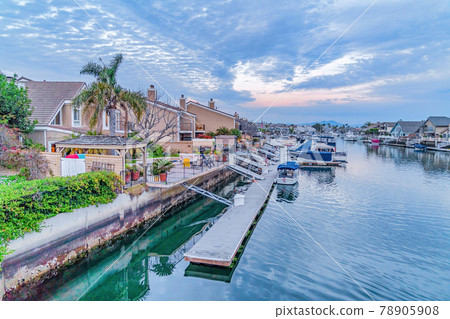 Houses overlooking the picturesque sea with docks and boats in Huntington Beach 78905908