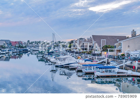 Brilliant scenery at the serene harbor of Huntington Beach California at sunset Brilliant scenery at the serene harbor of Huntington Beach California at sunset 78905909