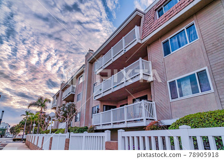 Apartments with private balconies and view of the street in Huntington Beach CA 78905918