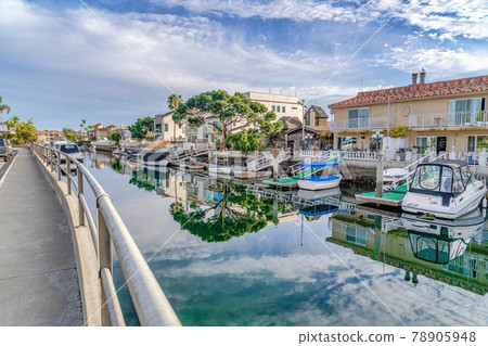 Canal and road in scenic coastal neighborhood of Huntington Beach California Canal and road in scenic coastal neighborhood of Huntington Beach California 78905948