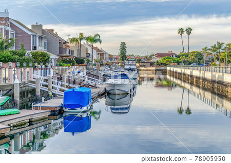 Yachts on docks of canal viewed from houses of Huntington Beach neighborhood Yachts on docks of canal viewed from houses of Huntington Beach neighborhood 78905950