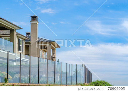 Exterior of houses in Huntington Beach California with glass fences against sky Exterior of houses in Huntington Beach California with glass fences against sky 78906005
