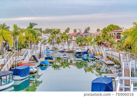 Scenic canal with stairs going down boat ramps at a resort like neighborhood 78906016