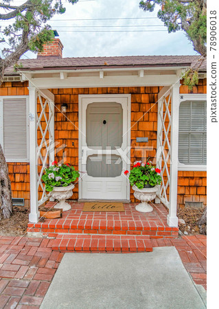 Beautiful facade of house with steps portico and storm door at the entrance 78906018