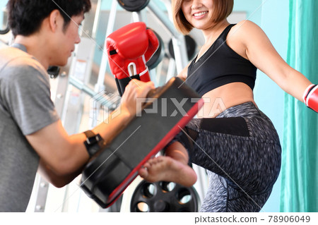 Female and male trainers kicking mitts 78906049