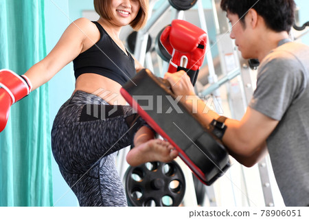 Female and male trainers kicking mitts 78906051