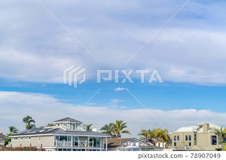 Picturesque skyscape of blue sky and clouds over beautiful waterfront houses 78907049
