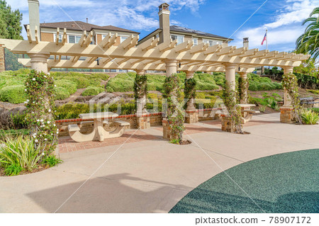 Pergola with vines and sitting areas in Huntington Beach California neighborhood 78907172