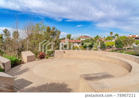 Circular patio with built in bench against homes in Huntington Beach California 78907211