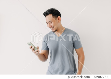 Happy man use smartphone isolated on white background. 78907282