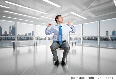 young businessman on a chair 78907474