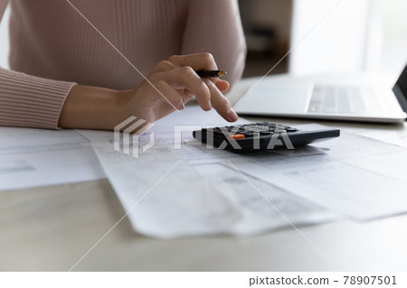 Close up of woman manage finances at home 78907501