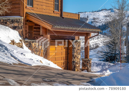 Home exterior in Park City Utah against blue sky and snow dusted hill in winter Home exterior in Park City Utah against blue sky and snow dusted hill in winter 78909180
