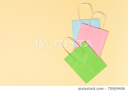 Colorful paper shopping bags on yellow background top view. Summer sale concept. 78909406