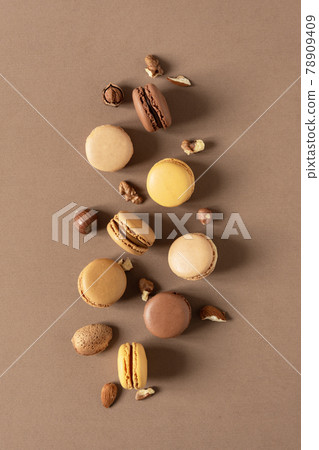 Nut macaroons dessert on brown background top view. 78909409