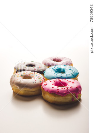 Multicolored sweet doughnuts on isolated white background 78909548