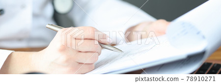 Doctor's hand makes note on medical documents Doctor's hand makes note on medical documents 78910271